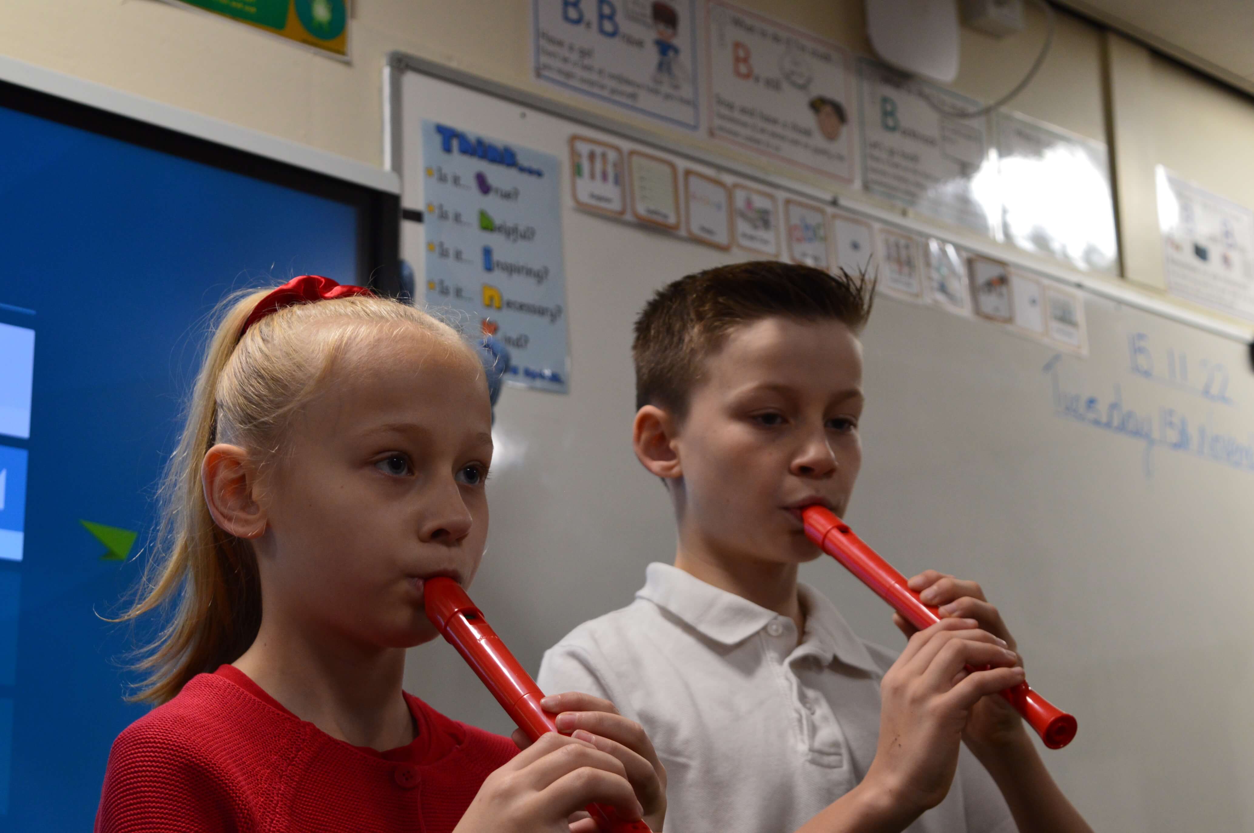 Kids in classroom play the pCorder.