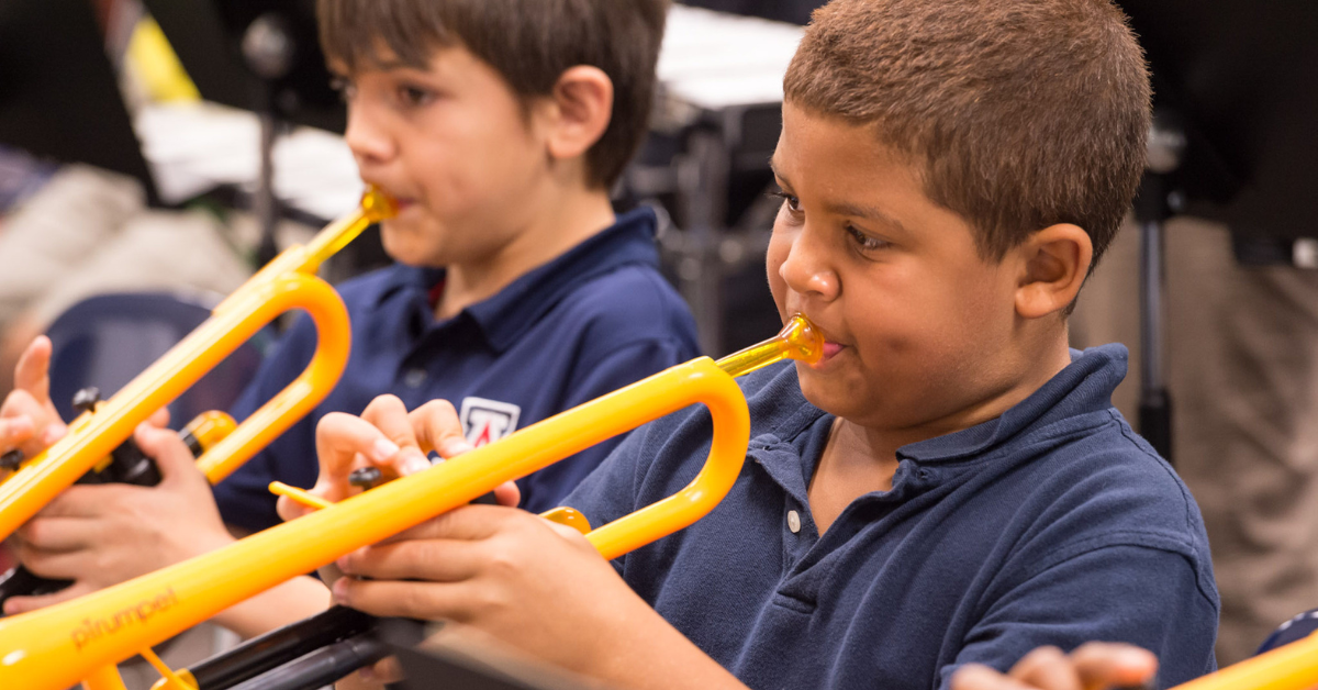 Children playing pTrumpets in school band.
