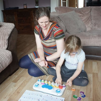 Child and parent playing with a Soundbops instrument