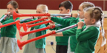 Children in school uniforms play pBuzz