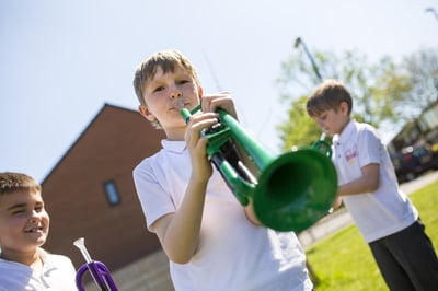 Children playing pTrumpet with Durham Brass