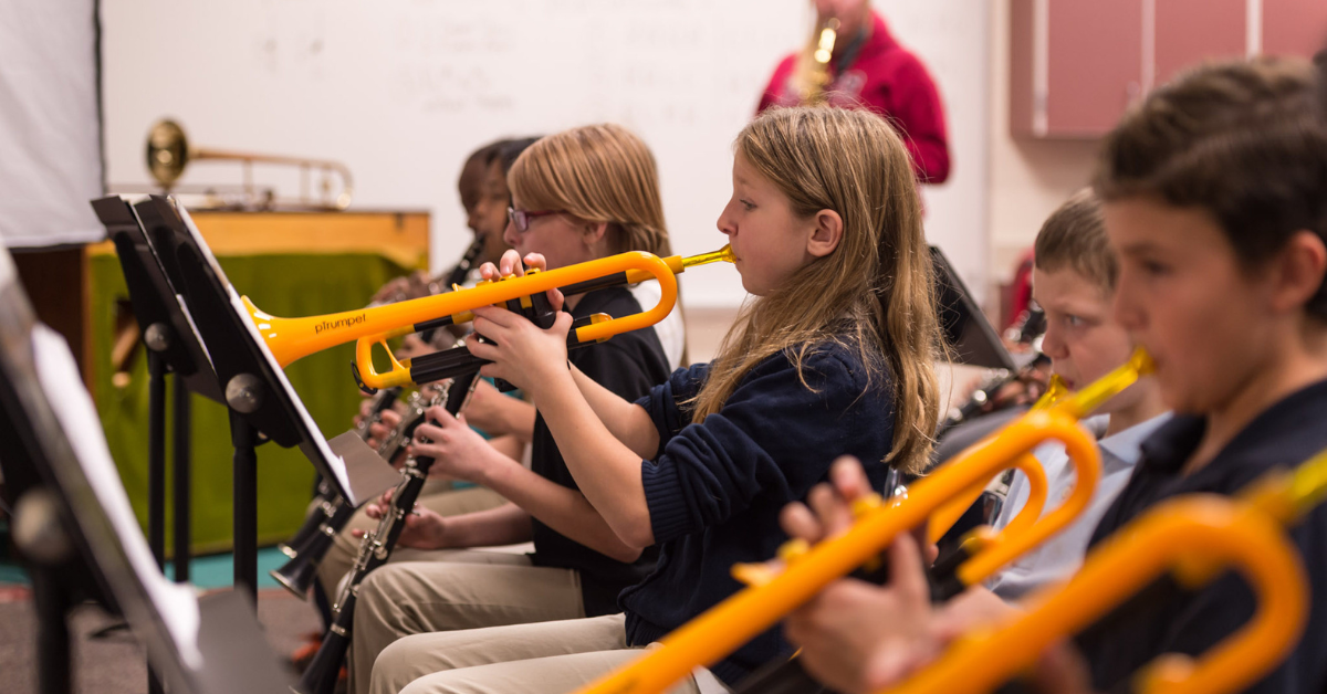 Children in a classroom playing the pTrumpet.